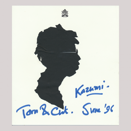 
        Front of silhouette, with boy looking right, wearing glasses. At the top an emblem; at the bottom, some hand-written text.